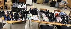 66 pairs of Nike shoes sit on two desk. 